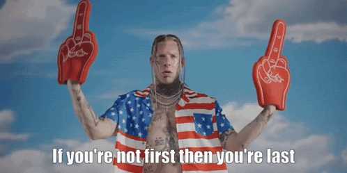 A Man In An American Flag Shirt Is Holding Up Boxing Gloves With The Words If You 'Re Not First Then You 'Re Last Below GIF