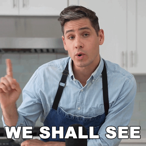 A Man In An Apron Says " We Shall See " In A Kitchen GIF