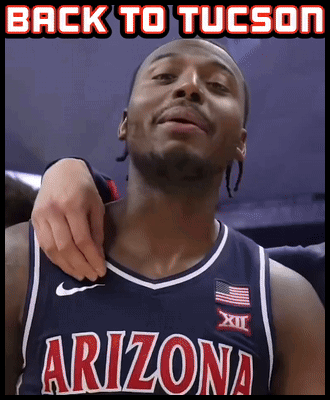 a man in an arizona jersey is being held by another man