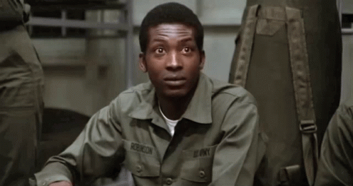 A Man In An Army Uniform Has The Name Robinson On His Chest GIF