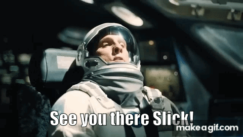 A Man In An Astronaut 'S Helmet Is Sitting In A Car And Says `` See You There Slick '' . GIF