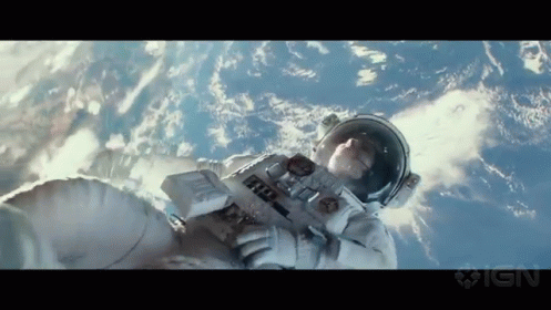 A Man In An Astronaut 'S Suit Is Floating In The Air GIF