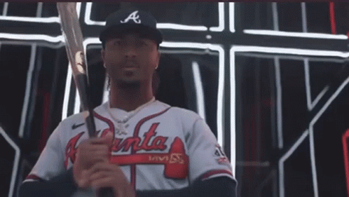 A Man In An Atlanta Braves Jersey Holds A Bat GIF