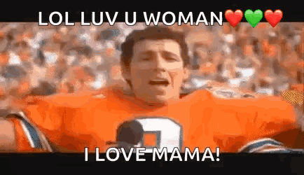 A Man In An Orange Football Jersey Is Holding A Microphone And Screaming . GIF