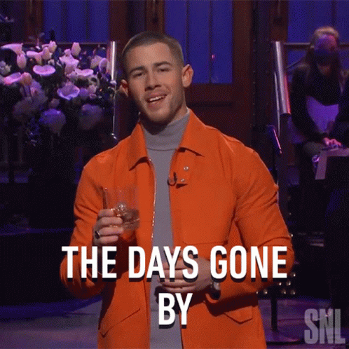 A Man In An Orange Jacket Holds A Glass Of Whiskey And Says The Days Gone By Snl GIF