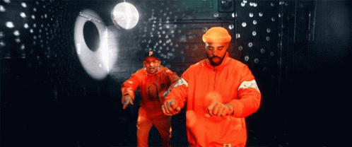 A Man In An Orange Jacket With The Letter P On It GIF