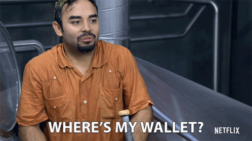 A Man In An Orange Shirt Is Asking Where 'S His Wallet GIF