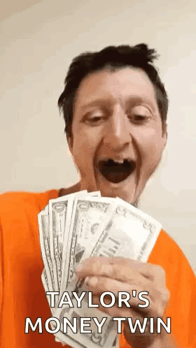 A Man In An Orange Shirt Is Holding A Bunch Of Money And Says Taylor 'S Money Twin . GIF