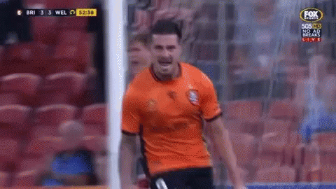 A Man In An Orange Shirt Is Standing In Front Of A Soccer Goal During A Game On Fox Sports GIF