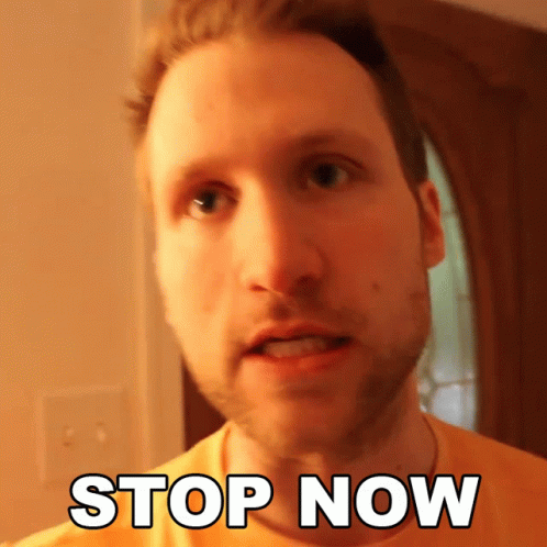 A Man In An Orange Shirt Says " Stop Now " In White Letters GIF