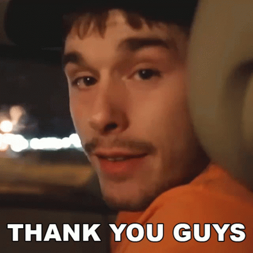 A Man In An Orange Shirt Says Thank You Guys In White Letters GIF
