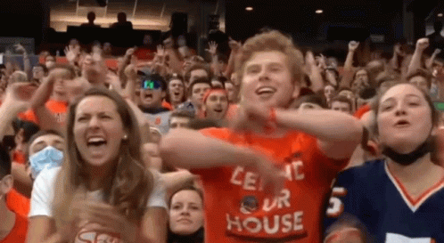 A Man In An Orange Shirt That Says " Let 'S Our House " GIF