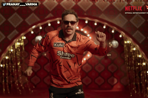 A Man In An Orange Shirt That Says Shree Cement GIF