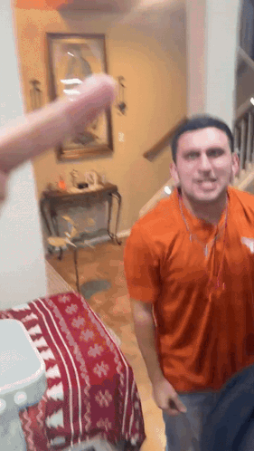 a man in an orange shirt with a texas logo on it