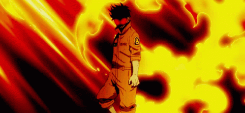 A Man In An Orange Uniform Is Standing In Front Of A Fire . GIF