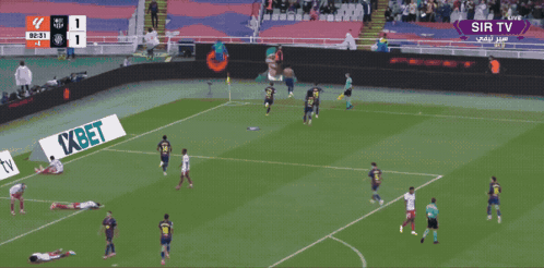 A Man In An Orange Vest That Says Barcelona On It Stands In A Stadium GIF