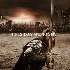 A Man In Armor Holding A Sword With The Words " This Day We Fight " Above Him GIF