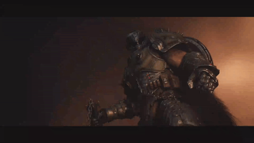 A Man In Armor Is Holding A Sword GIF
