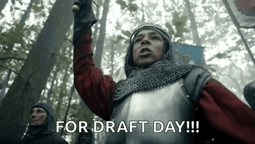 A Man In Armor Is Holding A Sword In A Forest And Says `` For Draft Day ! '' GIF