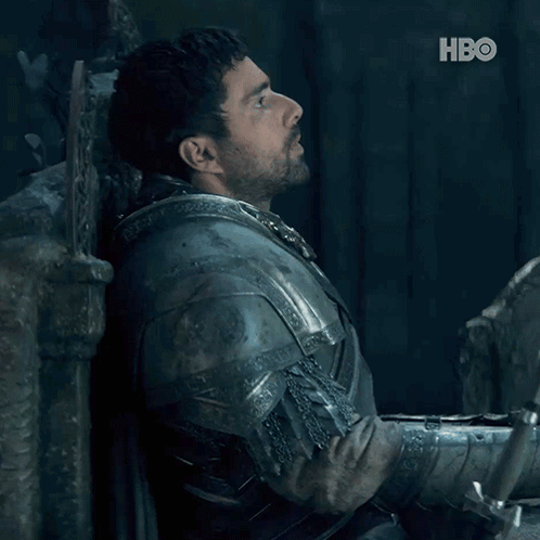 A Man In Armor Is Leaning Against A Wall And The Word No Is On The Bottom GIF
