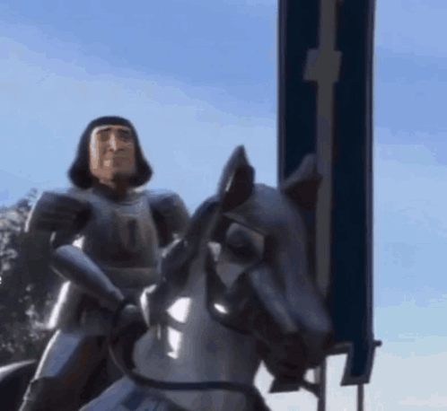 A Man In Armor Is Riding A Horse GIF