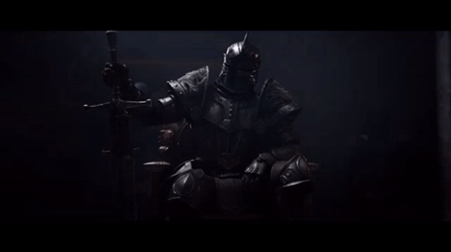 A Man In Armor Is Sitting On A Throne With A Sword GIF