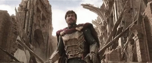 A Man In Armor Is Standing In Front Of A Destroyed Building GIF