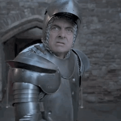 A Man In Armor Is Standing In Front Of A Window GIF
