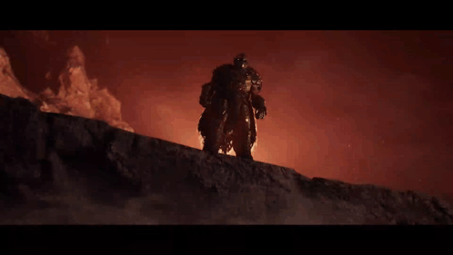 A Man In Armor Is Standing On Top Of A Rock GIF