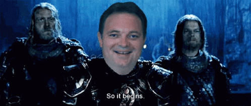 A Man In Armor Says So It Begins In Front Of Two Men GIF