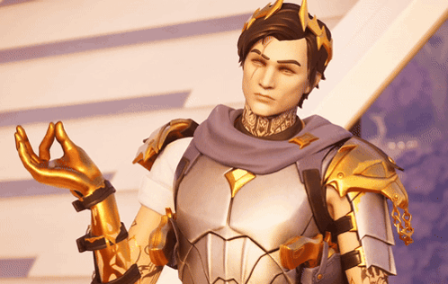 A Man In Armor With A Crown On His Head Is Making A Peace Sign GIF