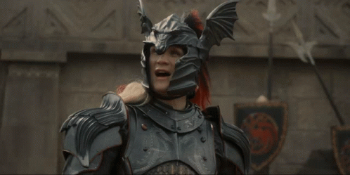 A Man In Armor With His Arms Outstretched Is Laughing GIF