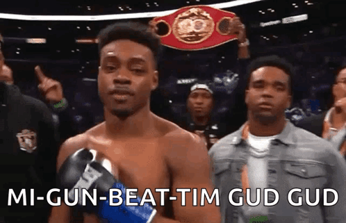 A Man In Boxing Gloves Is Holding A Boxing Championship Belt And Says " Mi-Gun-Beat-Tim Gud Gud " GIF