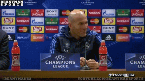 A Man In Front Of A Champions League Sign GIF