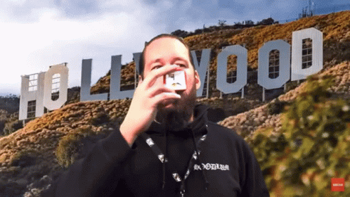 A Man In Front Of A Hollywood Sign GIF