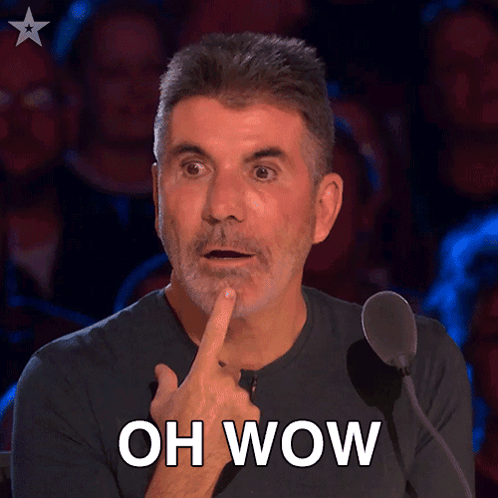 A Man In Front Of A Microphone With His Finger On His Chin And The Words Oh Wow Above Him GIF