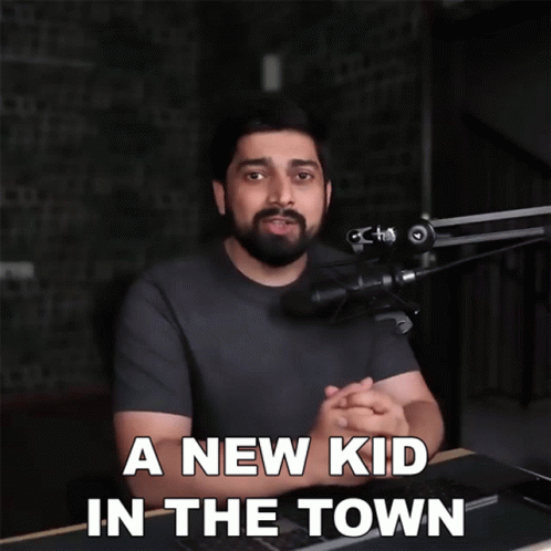 A Man In Front Of A Microphone With The Words " A New Kid In The Town " Below Him GIF
