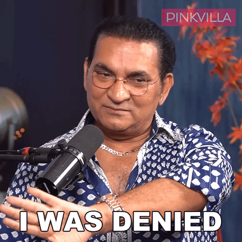 A Man In Front Of A Microphone With The Words I Was Denied Below Him GIF