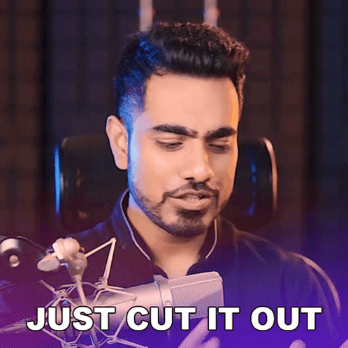 A Man In Front Of A Microphone With The Words Just Cut It Out Behind Him GIF