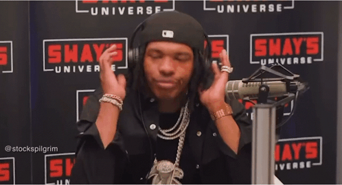 A Man In Front Of A Shaw 'S Universe Sign GIF