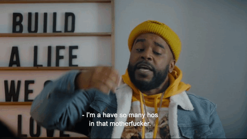 A Man In Front Of A Sign That Says " Build A Life " GIF