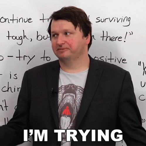 A Man In Front Of A White Board That Says I 'M Trying On It GIF