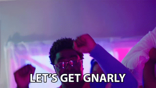 A Man In Glasses Says Let 'S Get Gnarly While Raising His Fist In The Air GIF