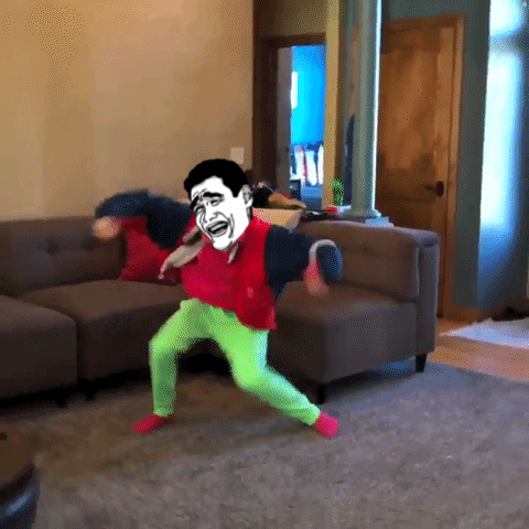 A Man In Green Pants Is Dancing In A Living Room GIF