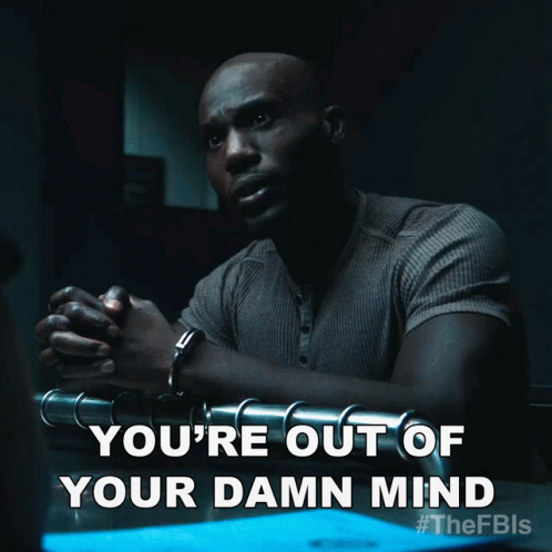 A Man In Handcuffs Is Sitting At A Table With The Words You 'Re Out Of Your Damn Mind GIF