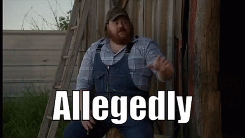 A Man In Overalls And A Plaid Shirt Is Sitting In Front Of A Wooden Fence With The Word Allegedly Written On It GIF