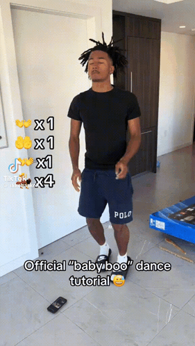 A Man In Polo Shorts Is Standing In A Room GIF