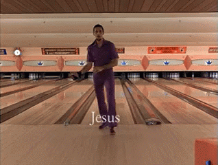 A Man In Purple Pants Is Standing On A Bowling Alley With The Word Jesus Written On The Floor GIF
