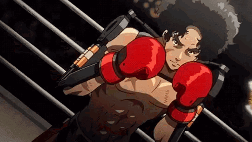 A Man In Red Boxing Gloves Is Standing In A Ring . GIF