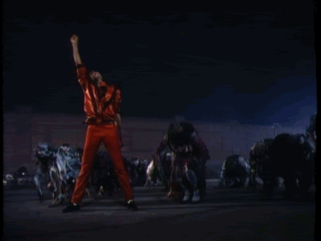 A Man In Red Pants Stands In Front Of A Crowd Of Zombies GIF